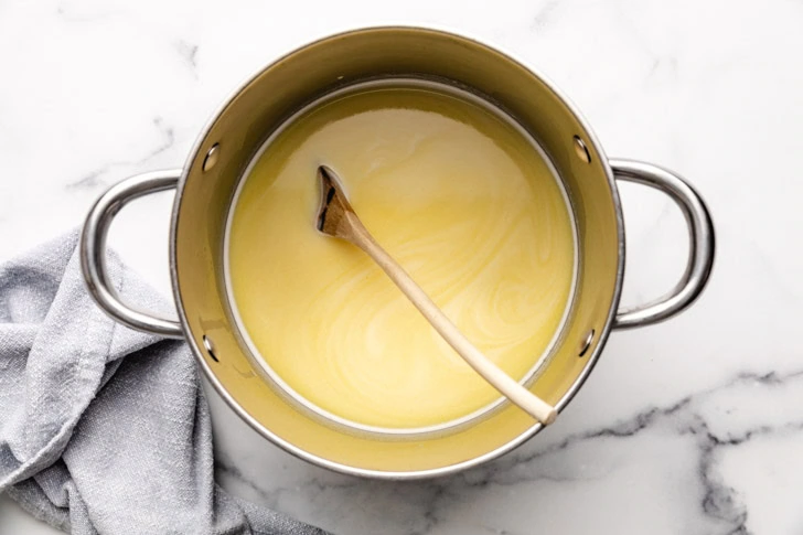 White chocolate melted into a pan of warm milk.