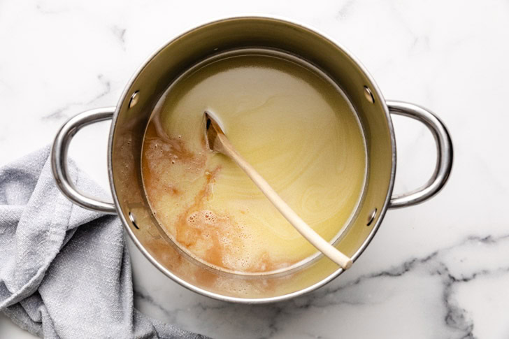 Espresso poured into a pan of warm white chocolate milk.