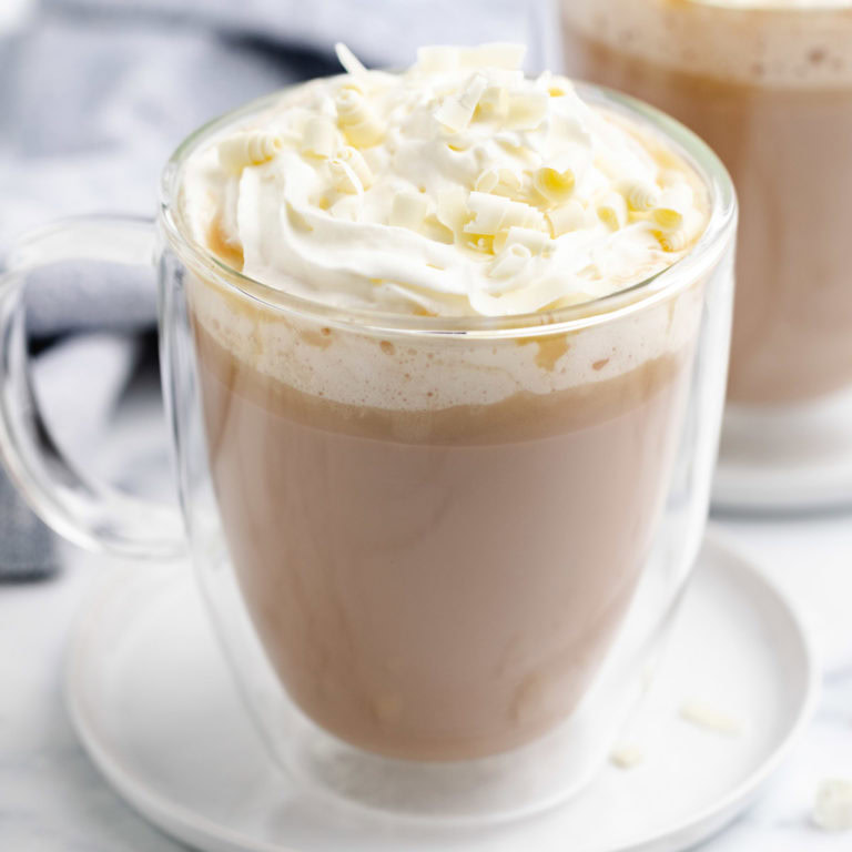 Mug filled with a warm coffee drink.