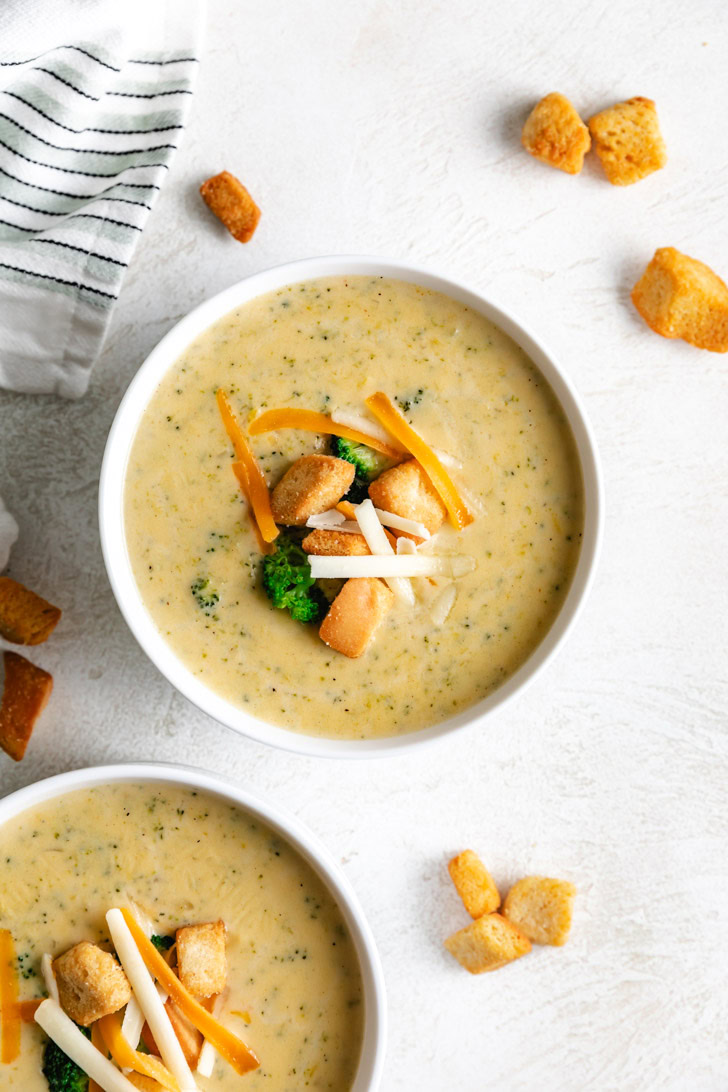 Overhead view of broccoli cheddar soup in a bowl.