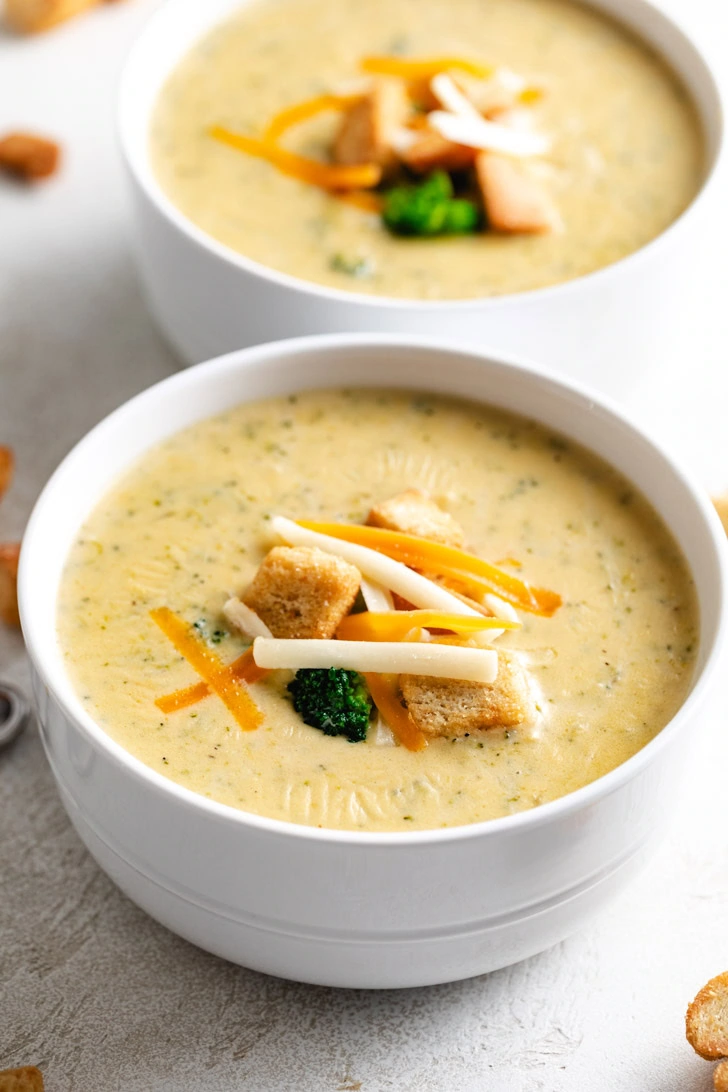 Cheese, croutons, and broccoli on a bowl of soup.