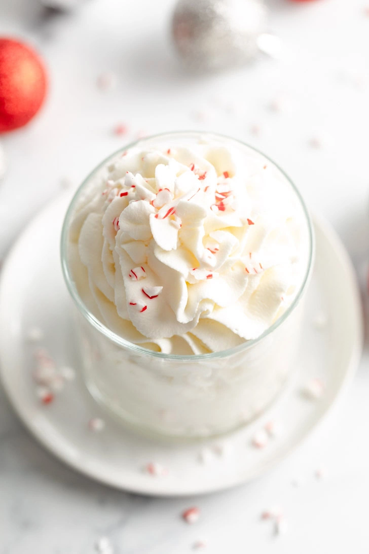 Top down view of peppermint whipped cream with crushed peppermint.