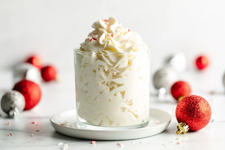 Festive flavored whipped cream in a container on a plate.