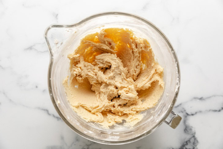 Cookie dough in a glass mixing bowl.