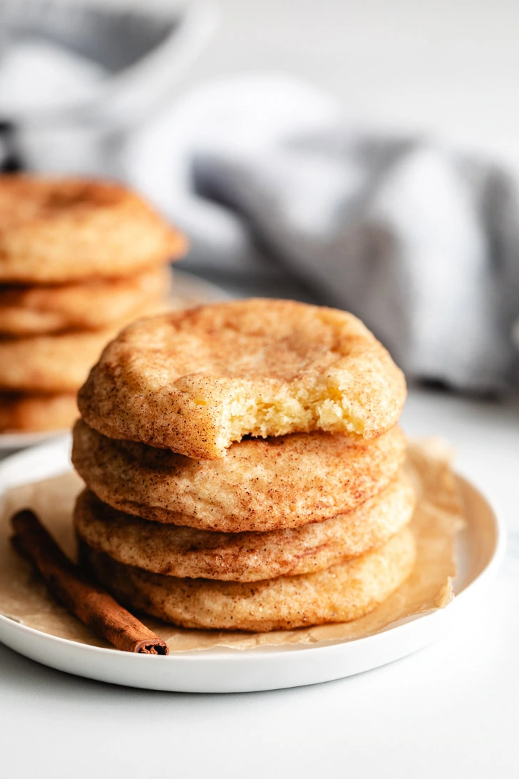 Stack of cookies on a white plate.