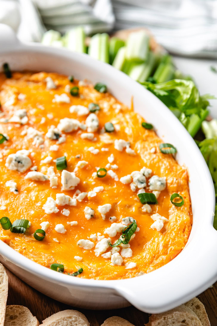 Oval dish filled with buffalo chicken dip.