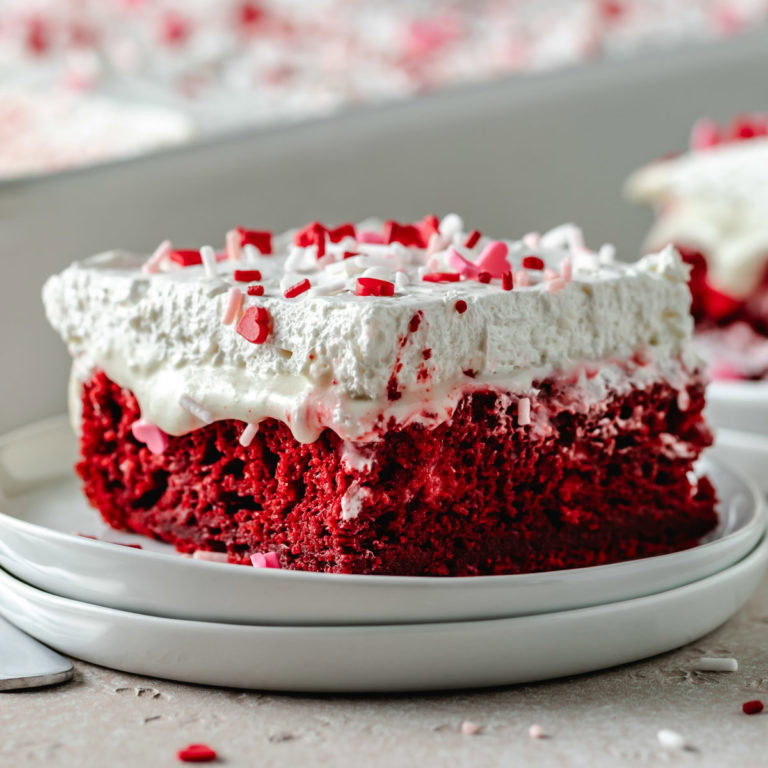 Red velvet poke cake with cream cheese filling.