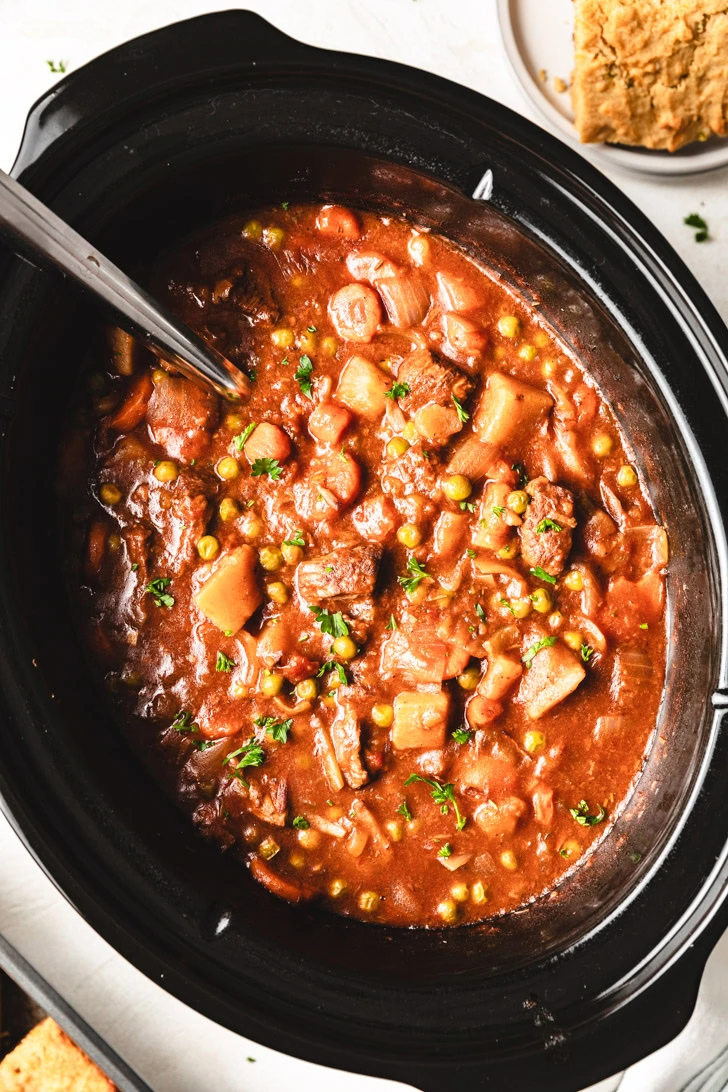 Overhead view of a crockpot filled with beef stew.