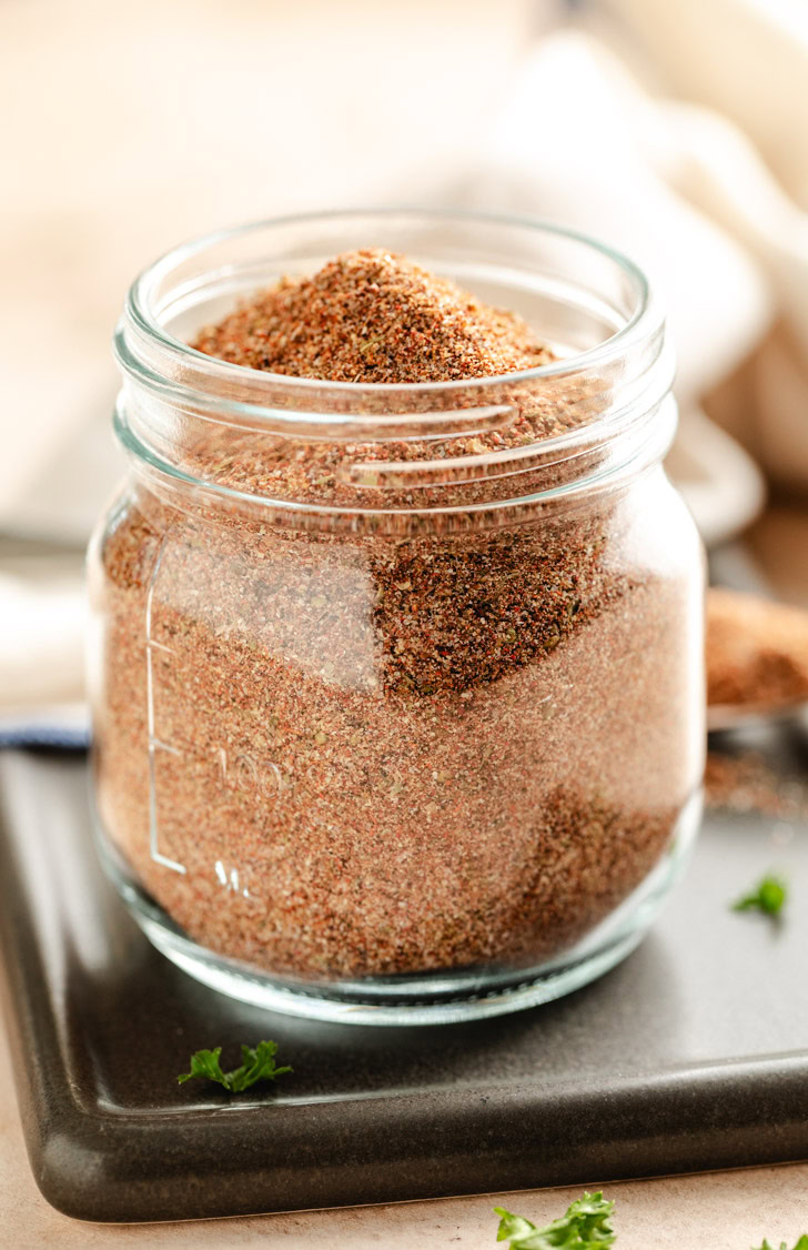 Homemade chili seasoning in a glass jar.