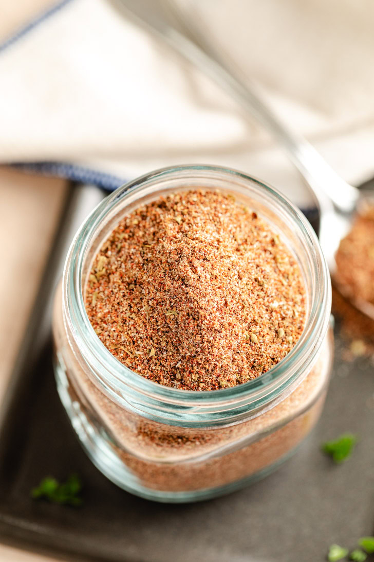 A jar filled with homemade chili seasoning mix.