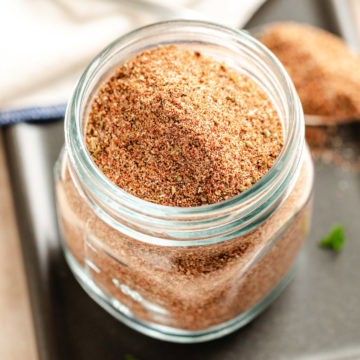 Close-up of a jar filled with homemade chili seasoning mix.