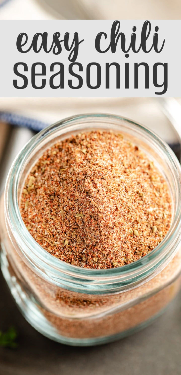 A glass jar filled with a homemade spice blend for chili.