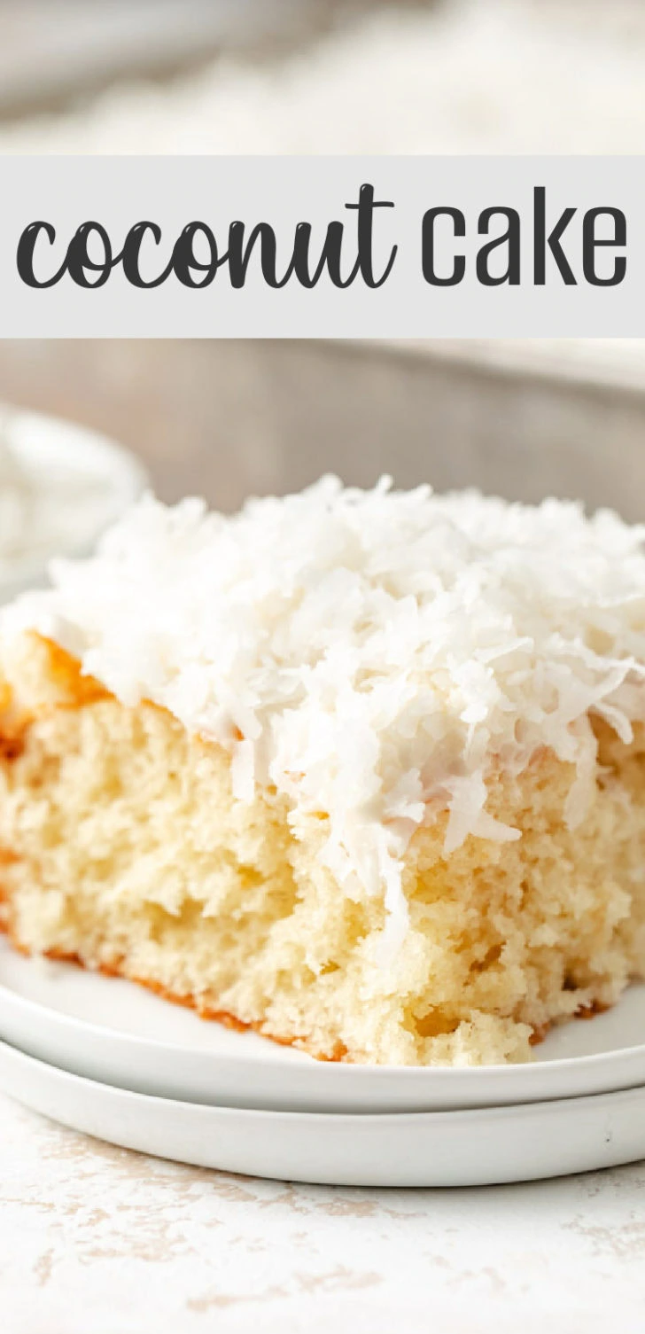 A fluffy slice of white cake with a coconut topping and smooth frosting.