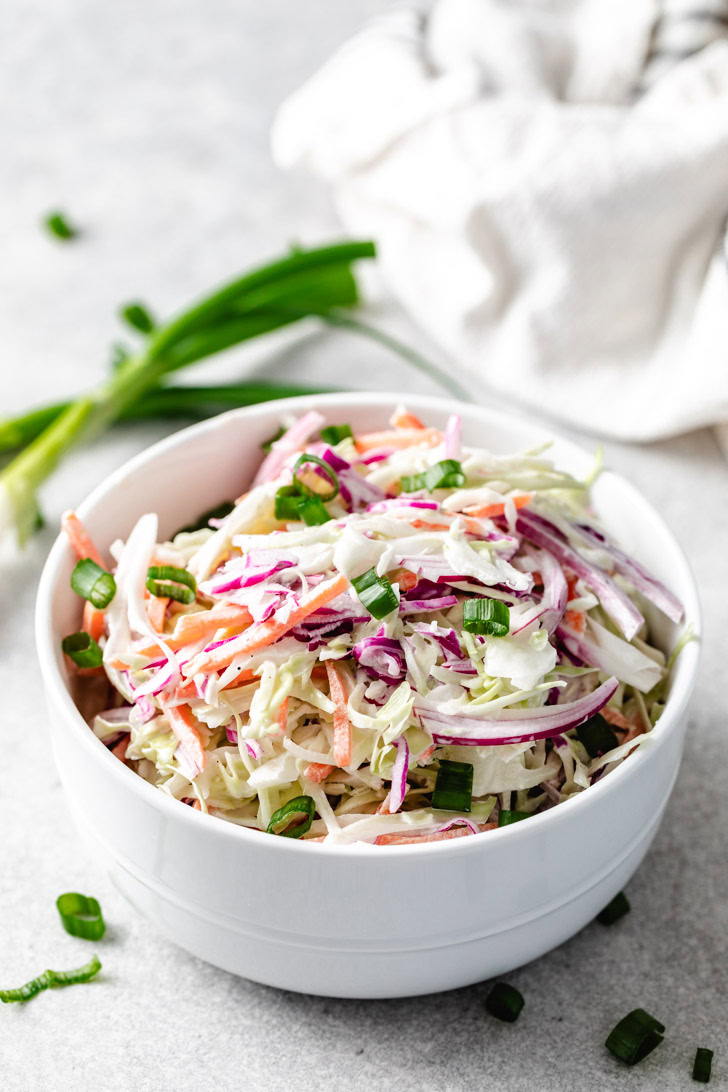 A bowl of homemade coleslaw with creamy dressing.