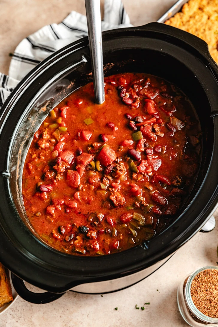 A crockpot filled with chili.