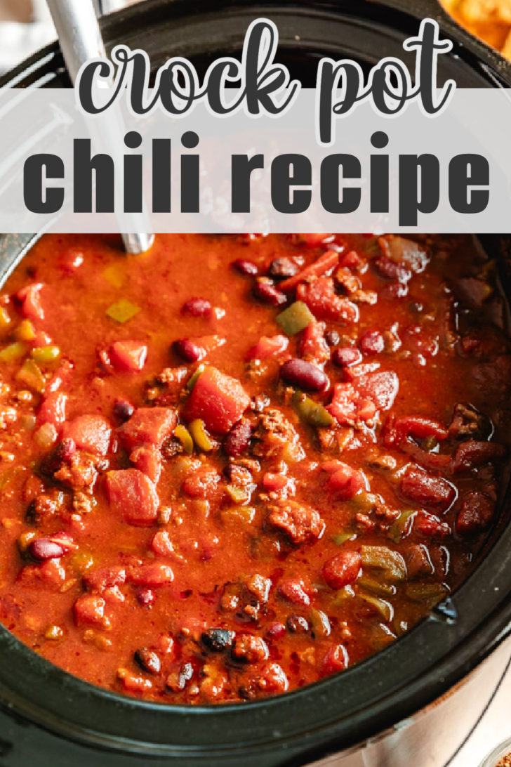 A crockpot filled with chili, simmering with tomatoes, beans, and spices.