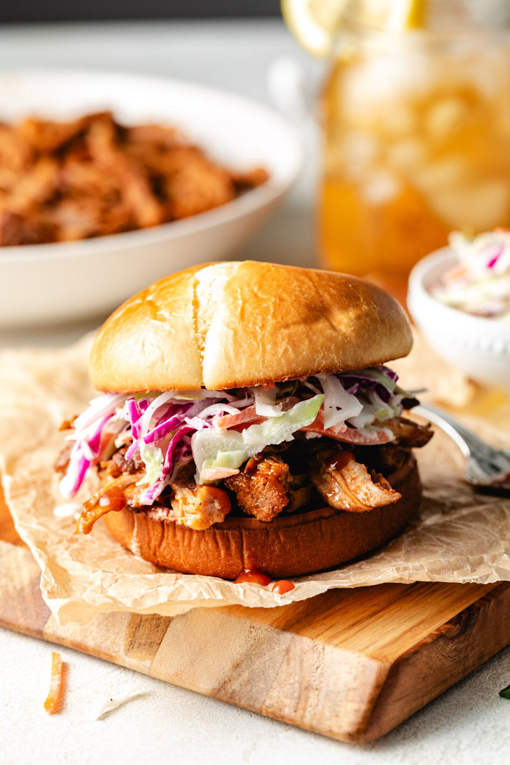 A slow cooker filled with shredded bbq pulled pork.