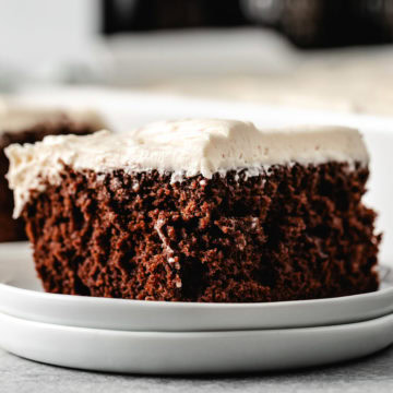 A slice of guinness chocolate cake with creamy baileys frosting.