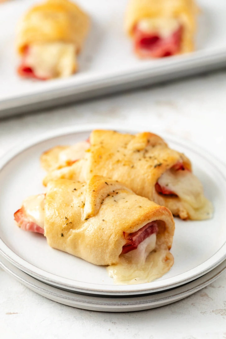 A plate of ham and cheese crescent rolls.