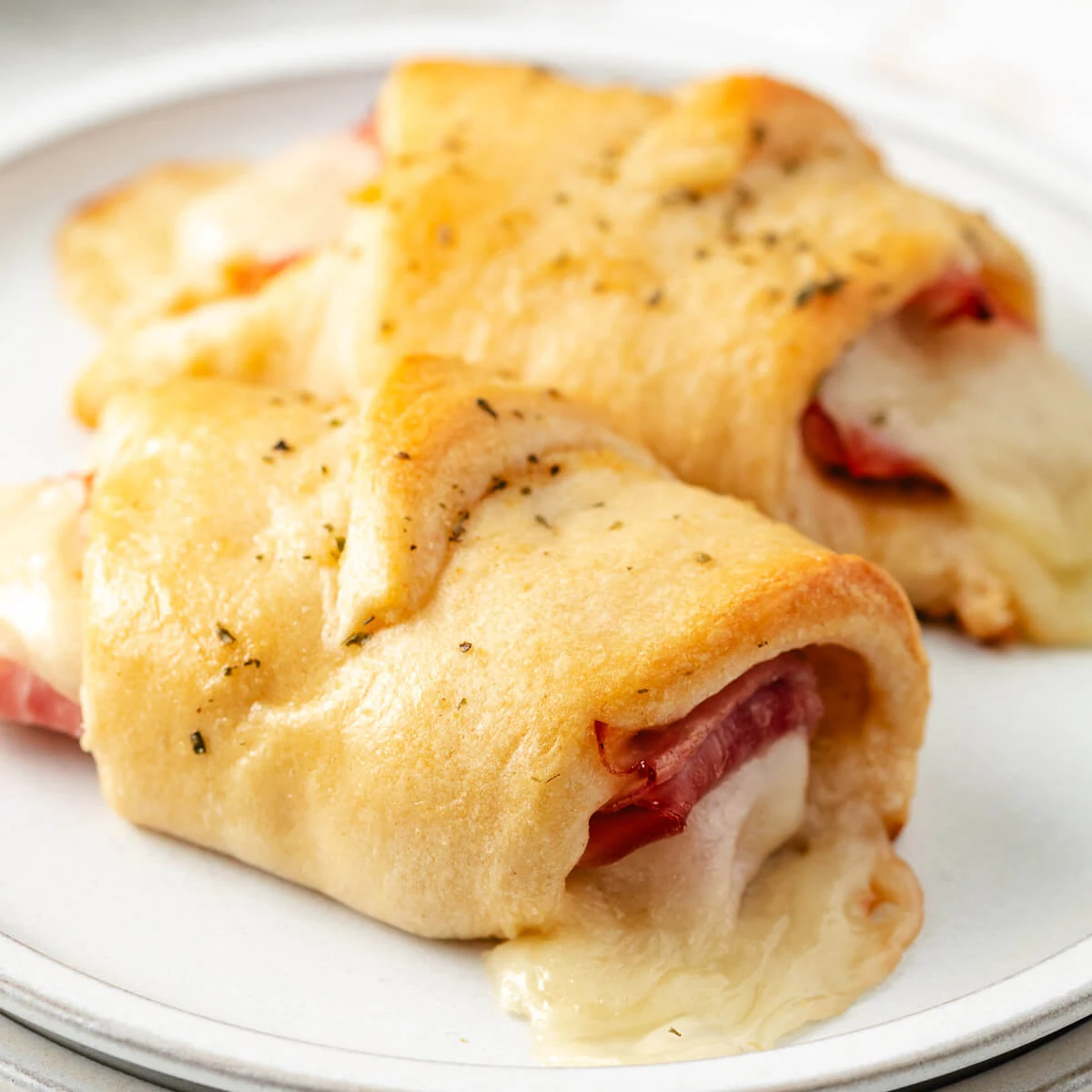 Close-up of ham and cheese crescent roll ups.