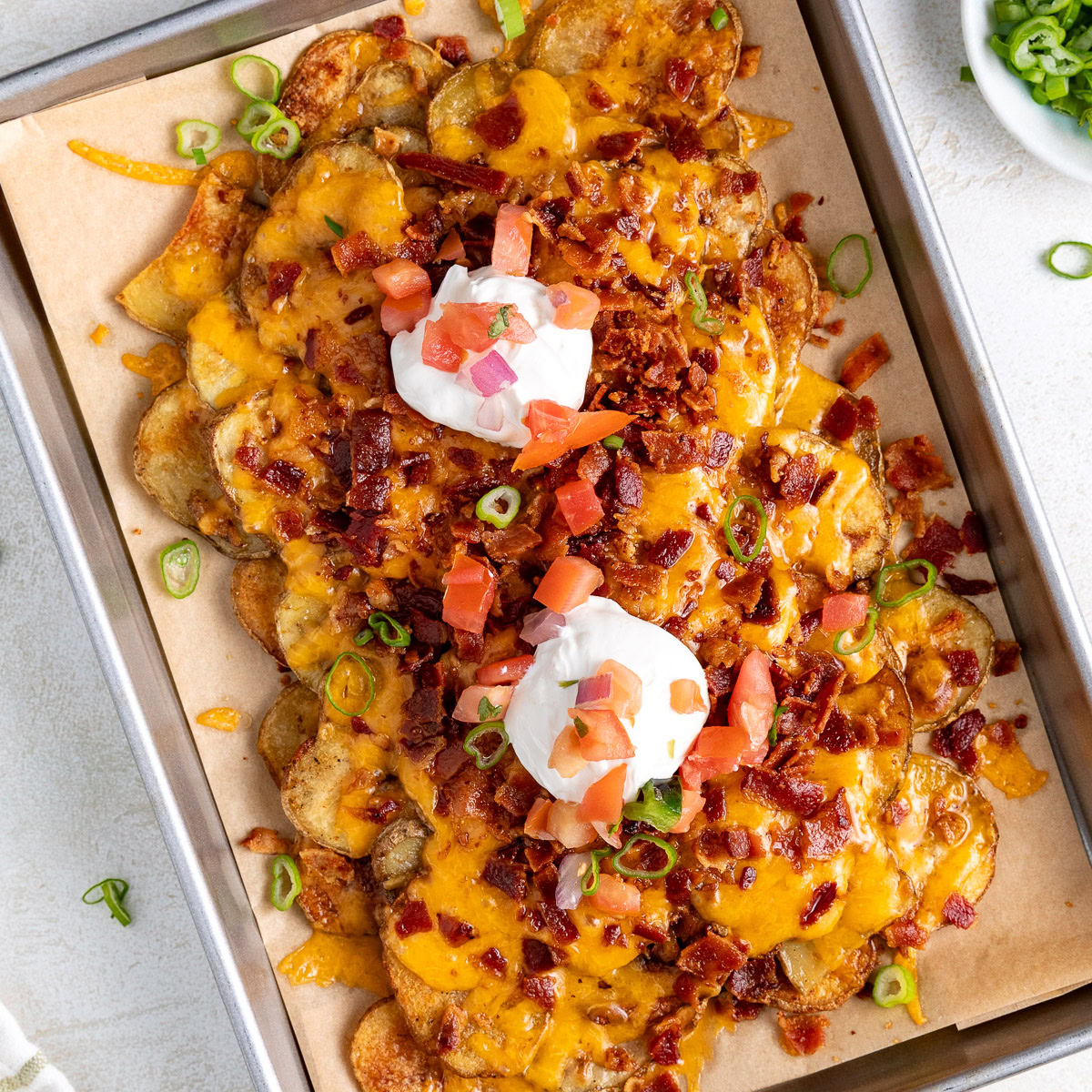 A sheet pan of crispy potato nachos.