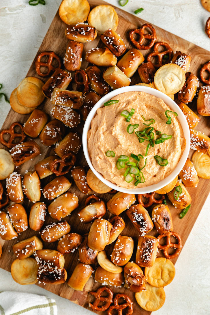 A top-down view of a serving board filled with pub cheese dip.