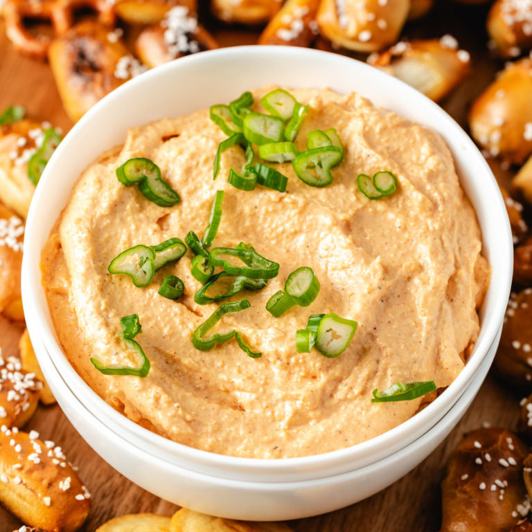 White bowl filled with beer cheese spread.