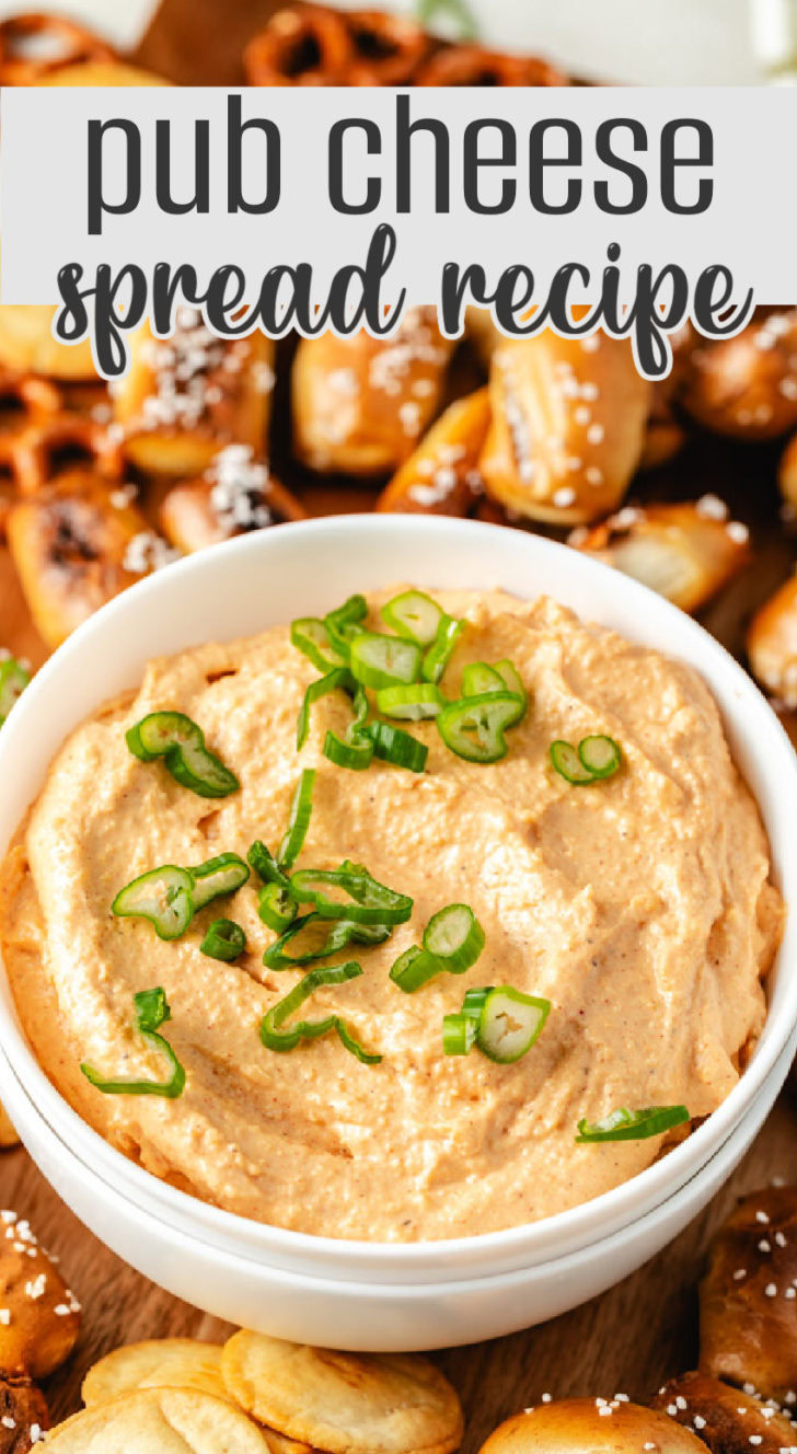 A creamy pub cheese spread in a white bowl, garnished with chopped green onions.